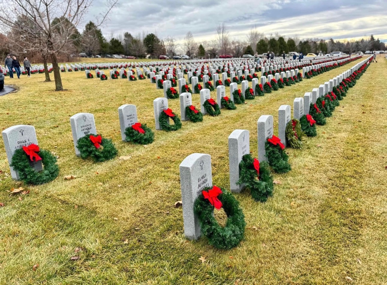 Rows of veterans’ headstones with green wreaths and red bows at the Idaho State Veterans Cemetery.
